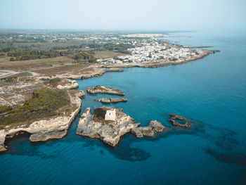 High angle view of sea and rocks against sky