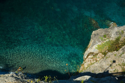 High angle view of rocks by sea