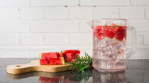 Fruits and ice cream in glass on table