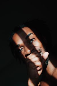 Sunlight falling on young man in darkroom