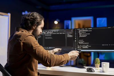 Side view of man working in office