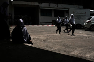 People on sidewalk at night