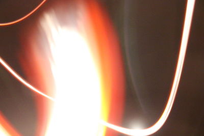 Close-up of illuminated lights against orange sky