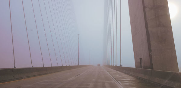 Road by fog against sky