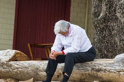 Full length of woman sitting outdoors