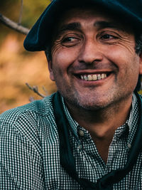 Close-up of thoughtful man smiling outdoors