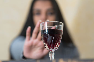 Midsection of woman holding wineglass