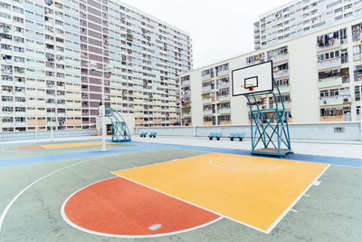 View of basketball court against buildings in city