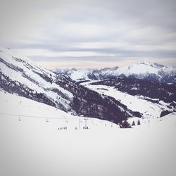 Scenic view of snow covered mountains against sky