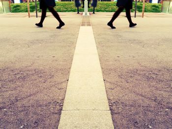 Low section of people walking on road