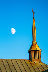 Low angle view of moon against blue sky
