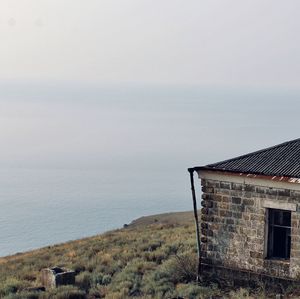 House by sea against sky