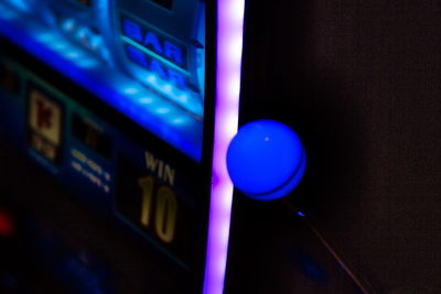 Low angle view of illuminated lighting equipment on wall