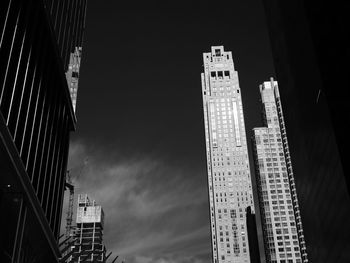Low angle view of buildings against sky at night