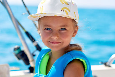 Portrait of happy boy against sea