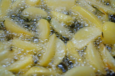 Full frame shot of french fries cooking in oil