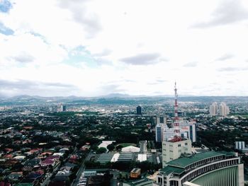 Cityscape against cloudy sky