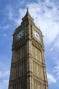 Low angle view of clock tower against cloudy sky