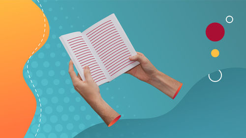 Midsection of person holding book against blue background
