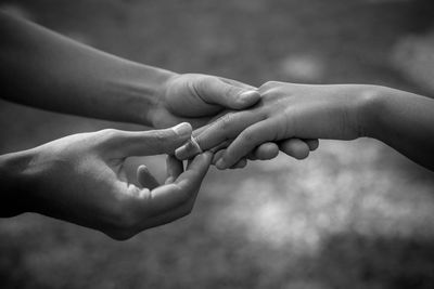 Midsection of couple holding hands