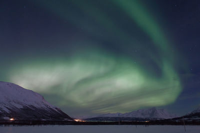 Scenic view of lake against sky at night