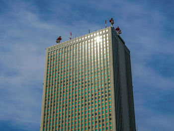 Low angle view of building against cloudy sky