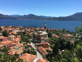 High angle view of town by sea against sky