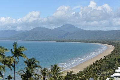 Scenic view of sea and mountains against sky