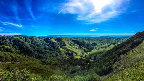 Scenic view of mountains against blue sky
