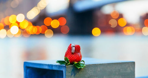 Close-up of engagement ring on strawberry
