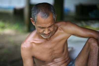 Portrait of shirtless man smiling