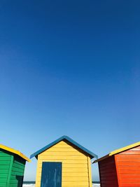 Low angle view of colourful buildings against blue sky