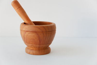 Close-up of bread on table against white background