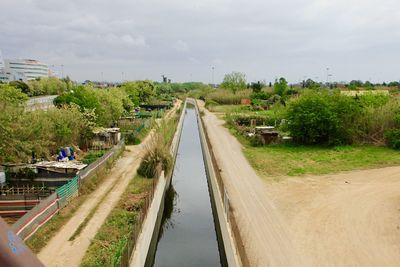 Panoramic shot of river amidst city against sky