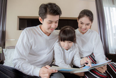 Young couple sitting on book