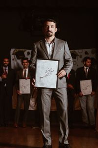 Portrait of friends standing on paper