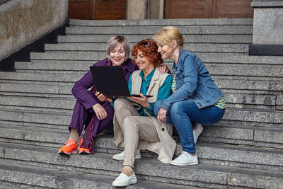 Friends sitting on staircase