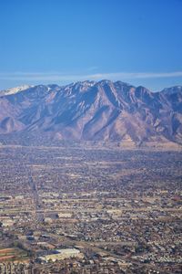 Scenic view of mountains against blue sky