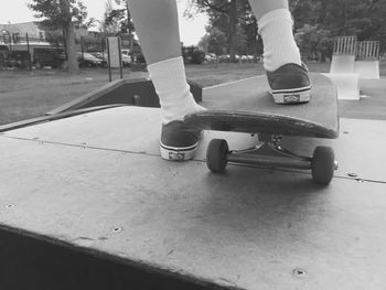 Low section of people standing on tree trunk