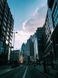 Street amidst buildings against sky in city