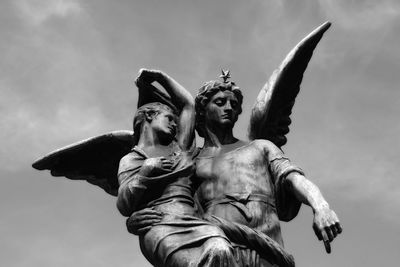 Low angle view of statues against sky