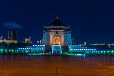 Illuminated building against sky at night