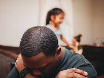 Close-up of man looking away while sitting at home