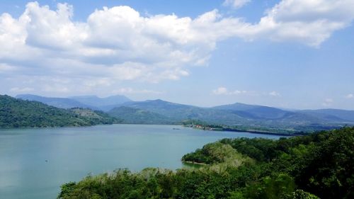 Scenic view of lake and mountains against sky