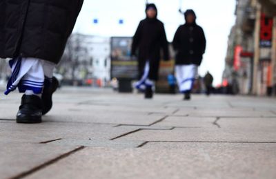 Surface level of people walking on road