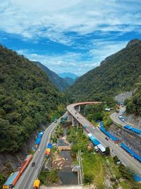 High angle view of road by mountains against sky