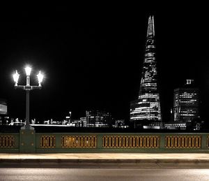 Illuminated city against sky at night