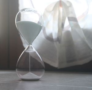 Close-up of hourglass on floor