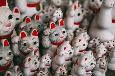 Close-up of maneki nekos for sale in market