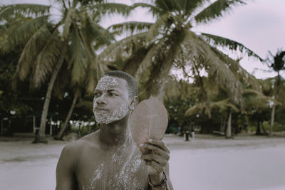 Portrait of shirtless man standing outdoors
